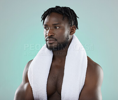 Buy stock photo Wellness, grooming and black man thinking of a shower, cleaning and isolated on a blue background. Beauty, health and African model with a towel for cosmetic morning routine on a studio backdrop