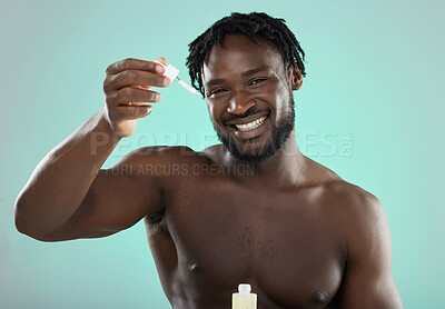 Buy stock photo Black man, studio and portrait with skincare serum, cosmetic beauty or grooming by blue background. Model, cosmetic and facial product for skin glow smile for aesthetic, cleaning or self care process