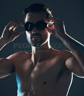 Buy stock photo Fitness, sports and face of swimmer with goggles isolated in studio for wellness, exercise and training. Workout, swimming athlete and man focus on dark background with muscle, strong body and tattoo