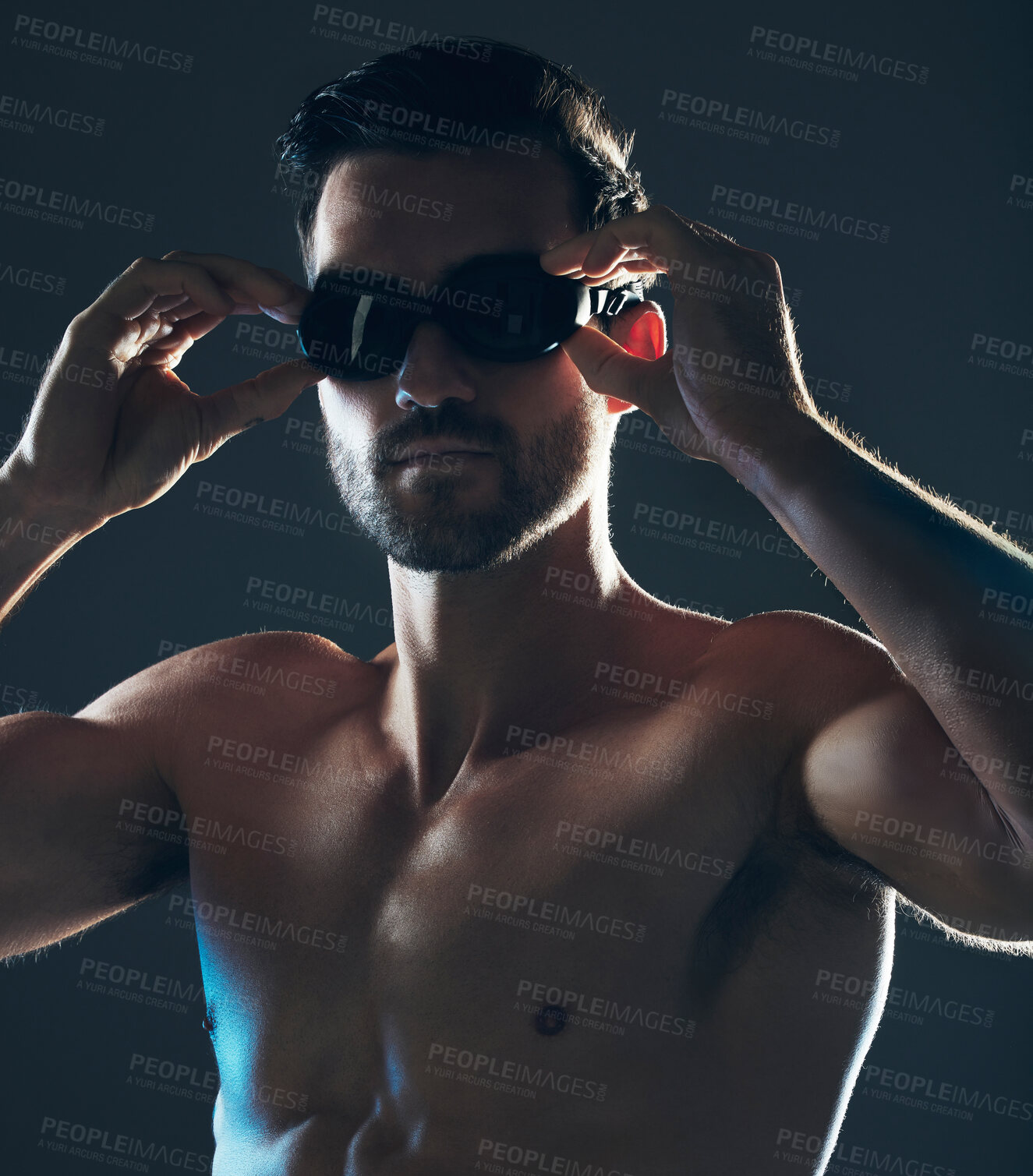 Buy stock photo Fitness, sports and face of swimmer with goggles isolated in studio for wellness, exercise and training. Workout, swimming athlete and man focus on dark background with muscle, strong body and tattoo