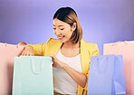 Check, shopping bag and happy woman for fashion sale, discount or retail prize on studio, purple background. Happy young model, asian person or customer with choice, giveaway and rich, wealth or gift