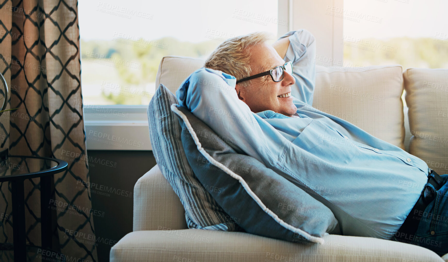 Buy stock photo Shot of a happy mature man relaxing on the sofa at home