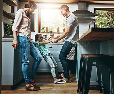 Buy stock photo Family, kitchen and dance together in home or bonding, child and father holdings hands, love and quality time in house. Girl, dad and mom with affection, fun and relax or dancing and laughing