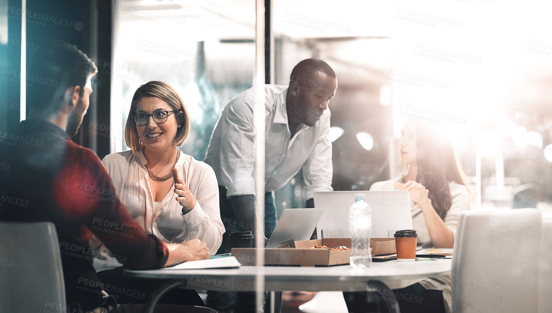 Buy stock photo Business, late night help and team at workshop with ideas, laptop and food planning startup project job. Teamwork, overtime and conversation, men and women brainstorming at creative marketing agency.