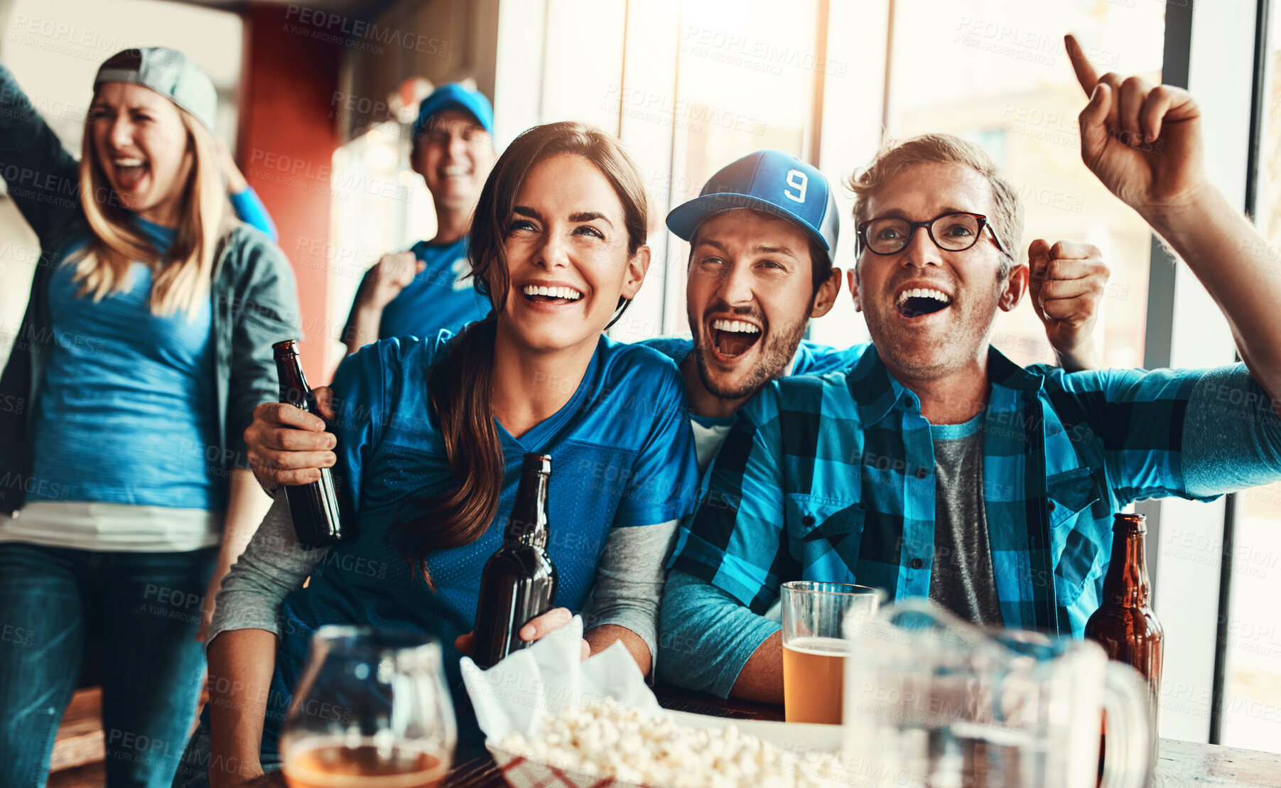 Buy stock photo People, supporters and team at pub, cheering for victory in sports on television with celebration for goal. Group, fans and beer for soccer, tournament or match as friends with loyalty in world cup