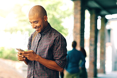 Buy stock photo Young man, student and texting with cellphone on campus, university and happy with social media app. Guy, smartphone and happiness outdoor for connectivity, blog and email communication on internet