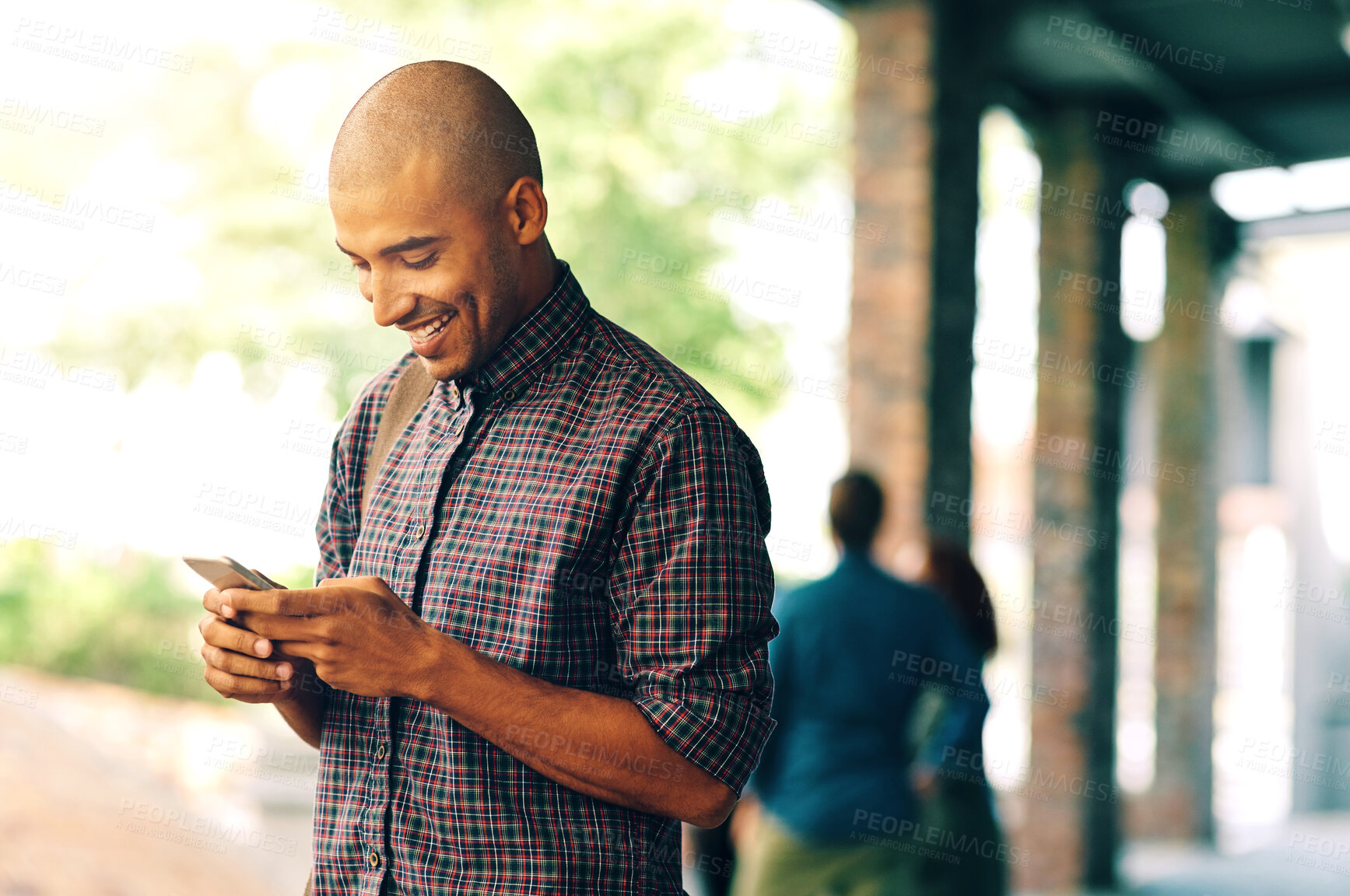 Buy stock photo Young man, student and texting with cellphone on campus, university and happy with social media app. Guy, smartphone and happiness outdoor for connectivity, blog and email communication on internet