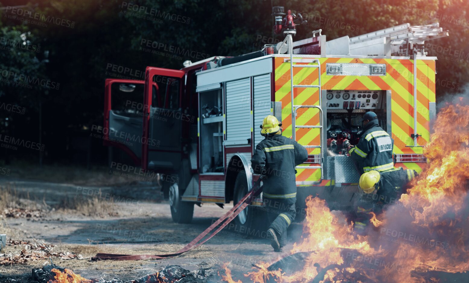 Buy stock photo Fire, teamwork and truck with firefighter and emergency in nature for smoke, safety and explosion. Danger, fearless and training with team of men in outdoor for rescue, saving operation and action