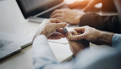 Buy stock photo A young man clipping his toenails on his desk at work