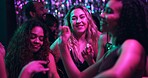 Dancing, festive and friends in club, night and fun for women, bonding and celebration in weekend or group. Lights, dark and listening to music, dancer and people in rave, disco and smile in New Year