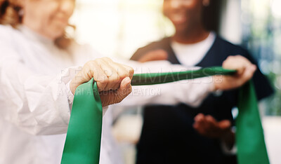 Buy stock photo Hands, rehabilitation or resistance band with patient and physiotherapist in clinic for recovery. Exercise, fitness or training with person and practitioner in office of hospital for improvement