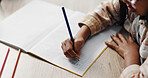 Hands, girl and kid with homework, writing and education with knowledge, learning and notebook. Apartment, student and childhood with creativity, pencils and growth with development, study or drawing