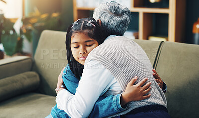 Buy stock photo Hug, therapist and girl child on couch with support, trust and professional care at pediatric clinic. Embrace, psychologist and sad kid on sofa in counseling for growth, development or mental health