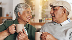 Retirement, old couple and smile for coffee, bonding and conversation in morning, love and happy in house. Living room, relax and nostalgia of relationship, talking and senior people with cups