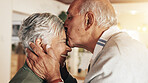 Senior couple, kiss and home with love, care and support together with retirement and marriage. Embrace, empathy and bonding with happy, smile and sweet comfort with elderly woman and anniversary