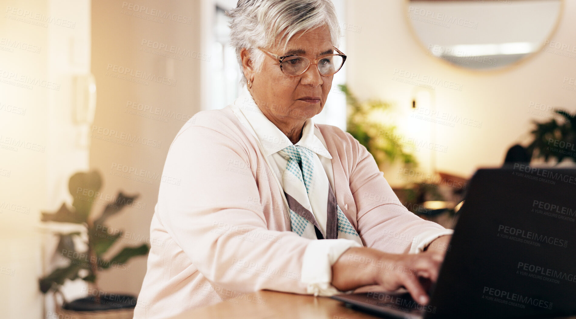 Buy stock photo Senior woman, typing or laptop in nursing home for planning, retirement budget or online medical appointment. Elderly person, tech or research in lounge for personal finance, banking and connectivity