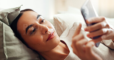 Buy stock photo Phone, relax and woman in bedroom in home with social networking, browsing and swiping on dating app. Calm, rest and female person laying on bed with cellphone for reading online blog in apartment.