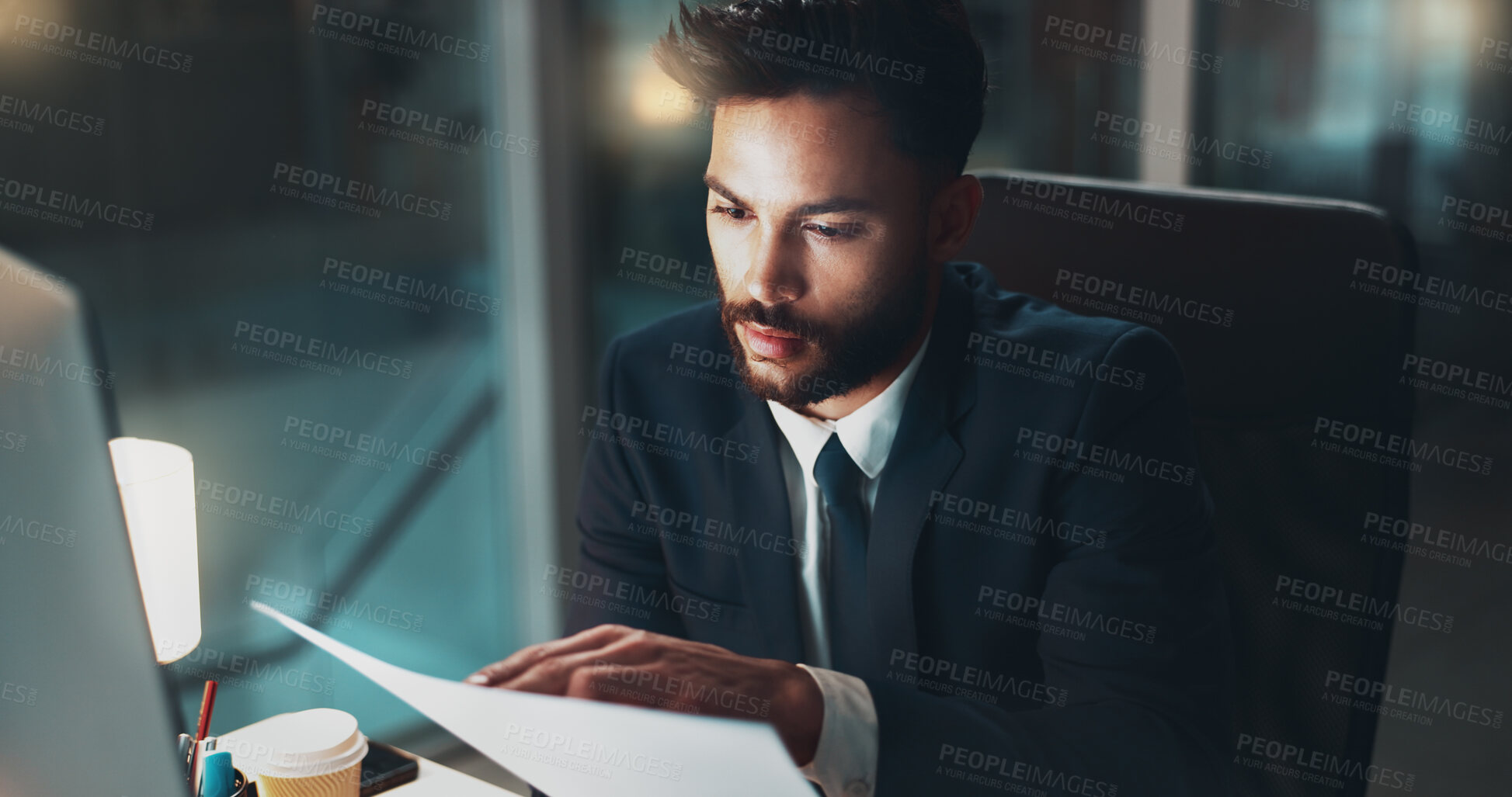 Buy stock photo Computer, night and reading with business man in office for administration or research. Documents, information and report with serious employee in workplace for deadline, overtime or review.