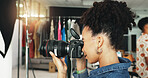 Photography, fashion and camera with woman in studio for magazine production, backstage and wardrobe set. Artist, photoshoot and creative with person for ecommerce catalog, shooting and picture