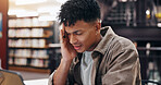 Man, student and tech in library with headache, stress and massage temple for relief. Person, laptop and migraine at university campus with fatigue, tension and tired with research or assignment