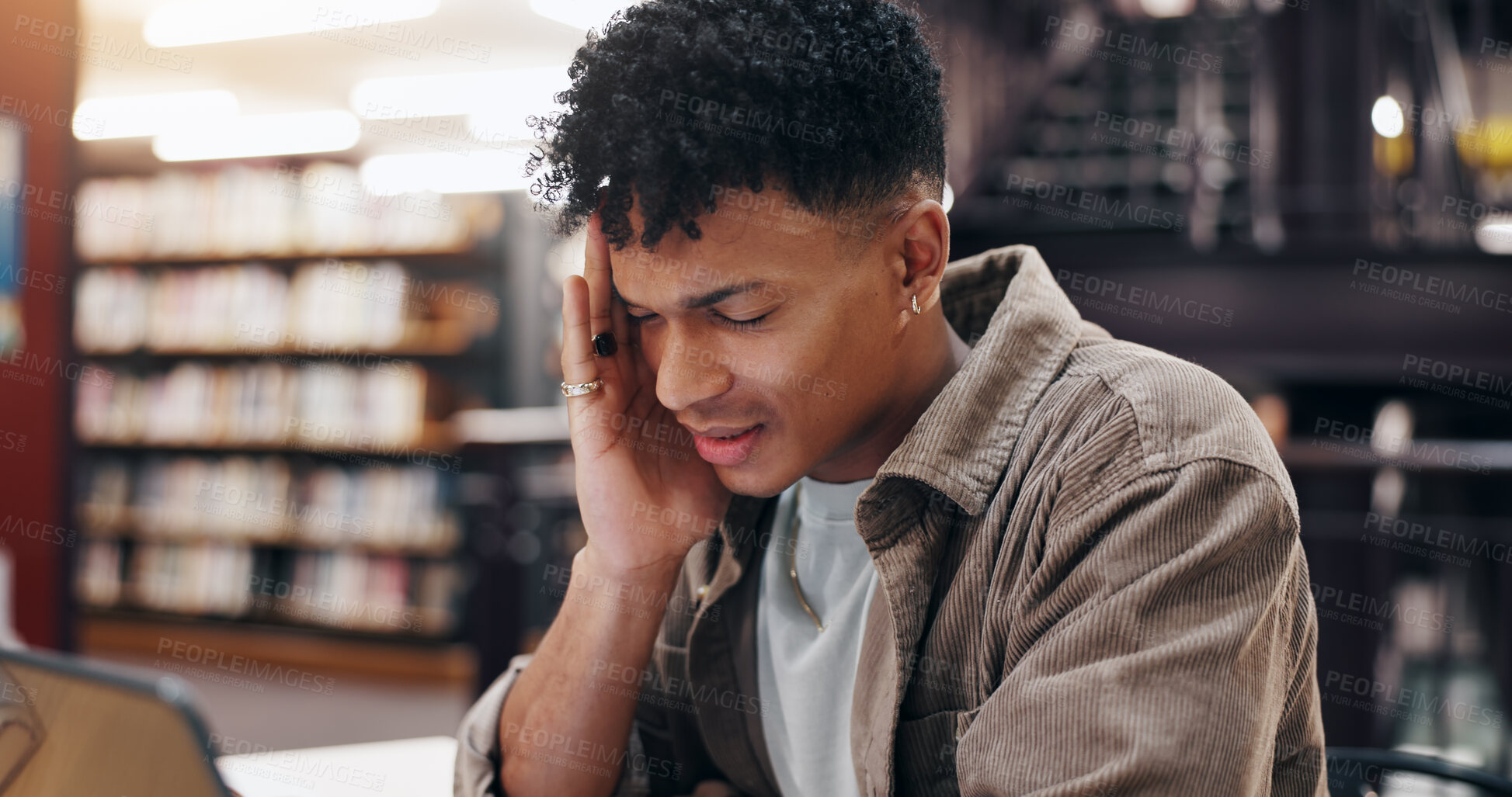 Buy stock photo Man, student and tech in library with headache, stress and massage temple for relief. Person, laptop and migraine at university campus with fatigue, tension and tired with research or assignment