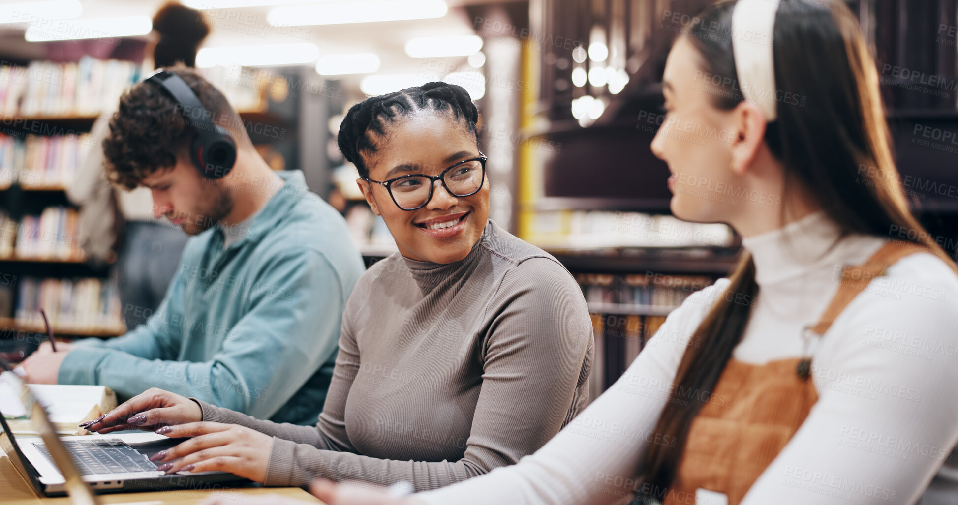 Buy stock photo Students, happy and laptop in library for learning, brainstorming and research assignment. Women, smile and tech in university for social media post, comedy literature and pleased with test results