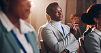 Business, man and pen with presentation seminar of conference, listening and corporate training for speech. Thinking, male person and crowd with meeting for learning, information and convention event
