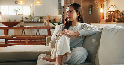 Buy stock photo Calm, mindful and thinking with woman on sofa in living room of home for contemplation or wellness. Future, idea and vision with serious person in apartment for memories, nostalgia or planning