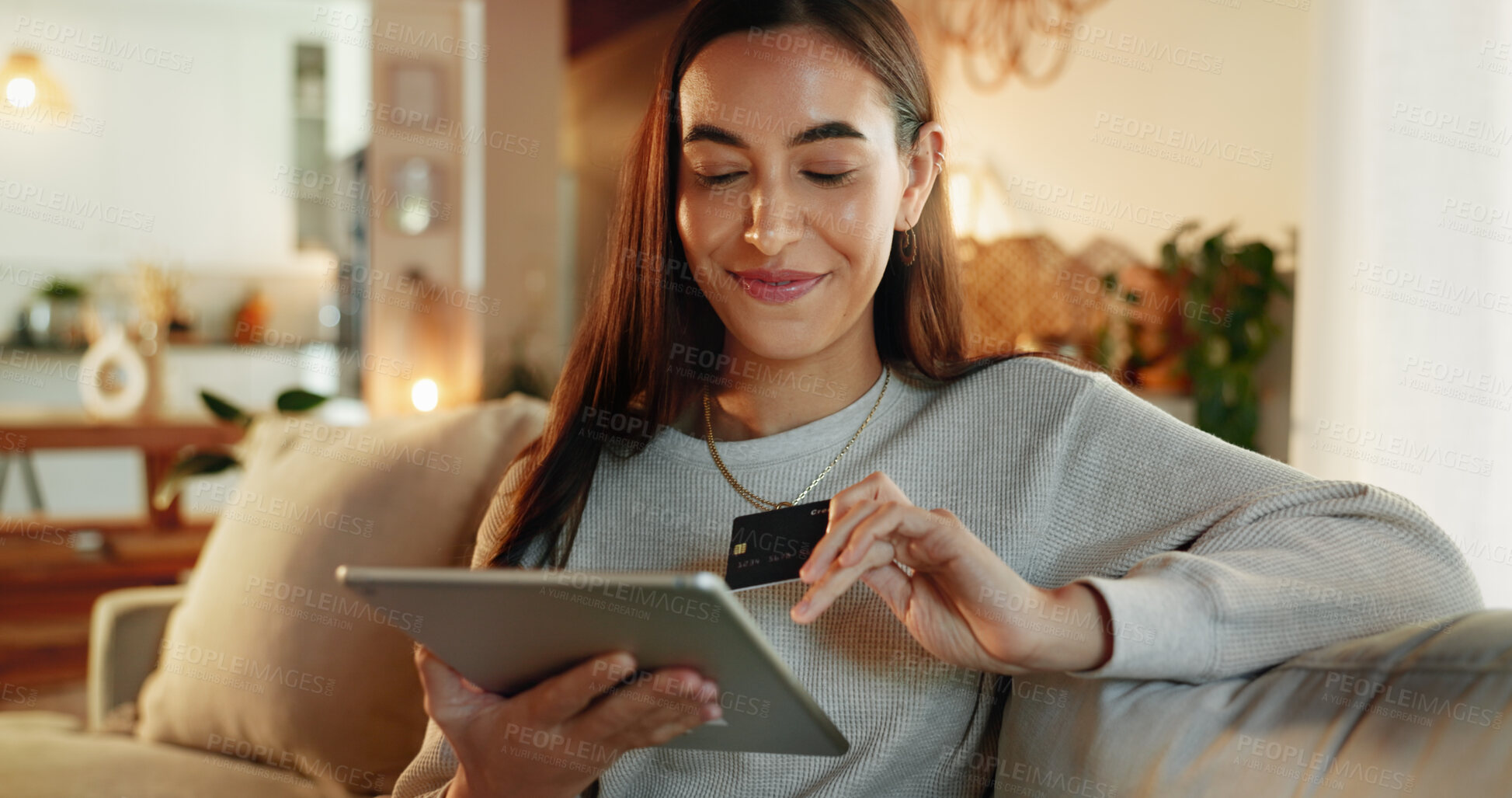 Buy stock photo Credit card, online shopping and tablet with woman on sofa in living room of home for payment at night. App, ecommerce and fintech with happy person in apartment for purchase, transaction or transfer