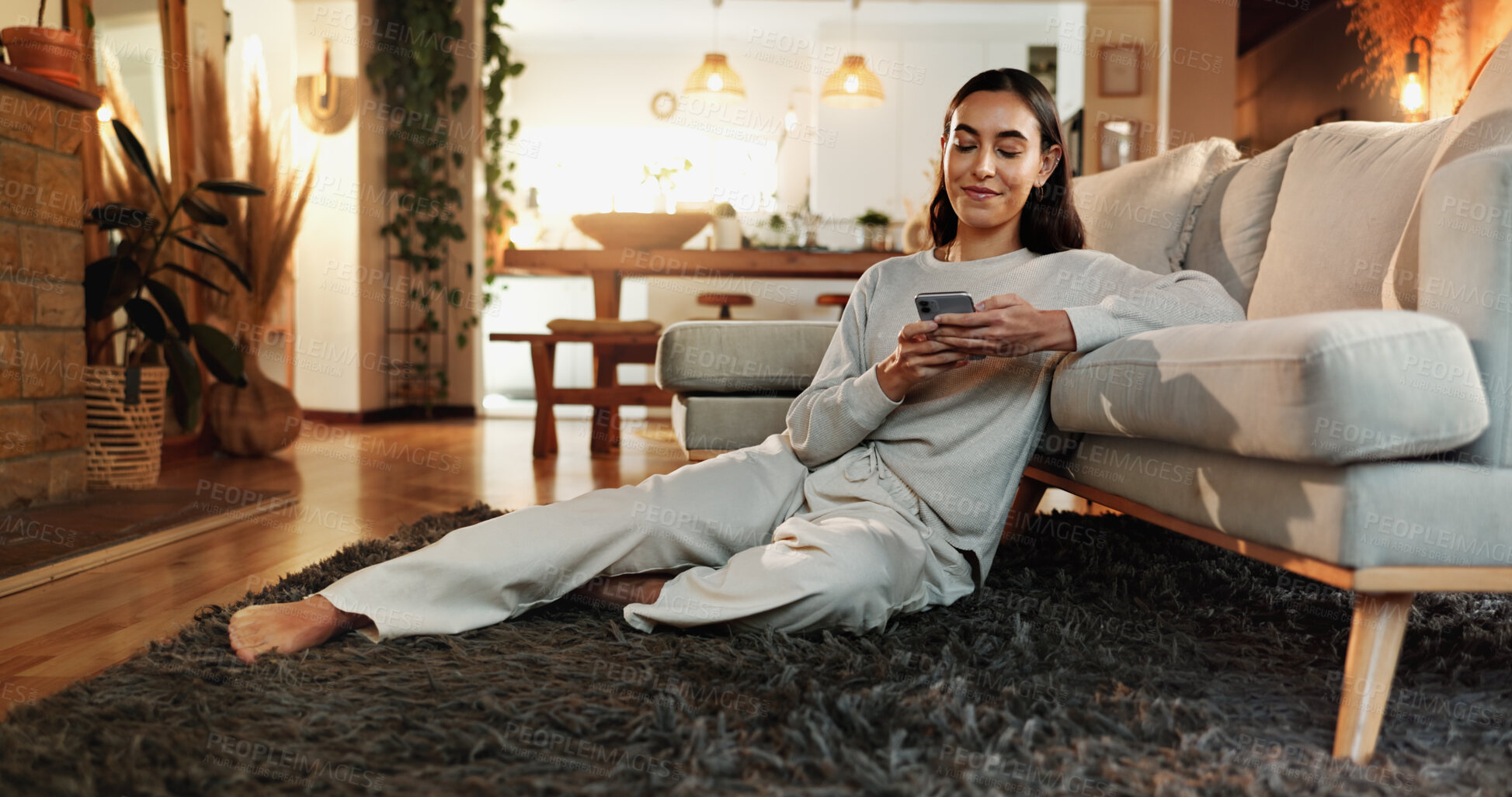 Buy stock photo App, happy and social media with woman on floor in home living room for communication or online shopping. Relax, search and wellness with smile of person in apartment for networking or text message