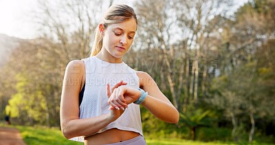 Buy stock photo Girl, runner and check smart watch in nature for running performance, tracking speed and fitness monitor. Athlete, person and biometric in forest for wellness progress, heart rate and workout outdoor