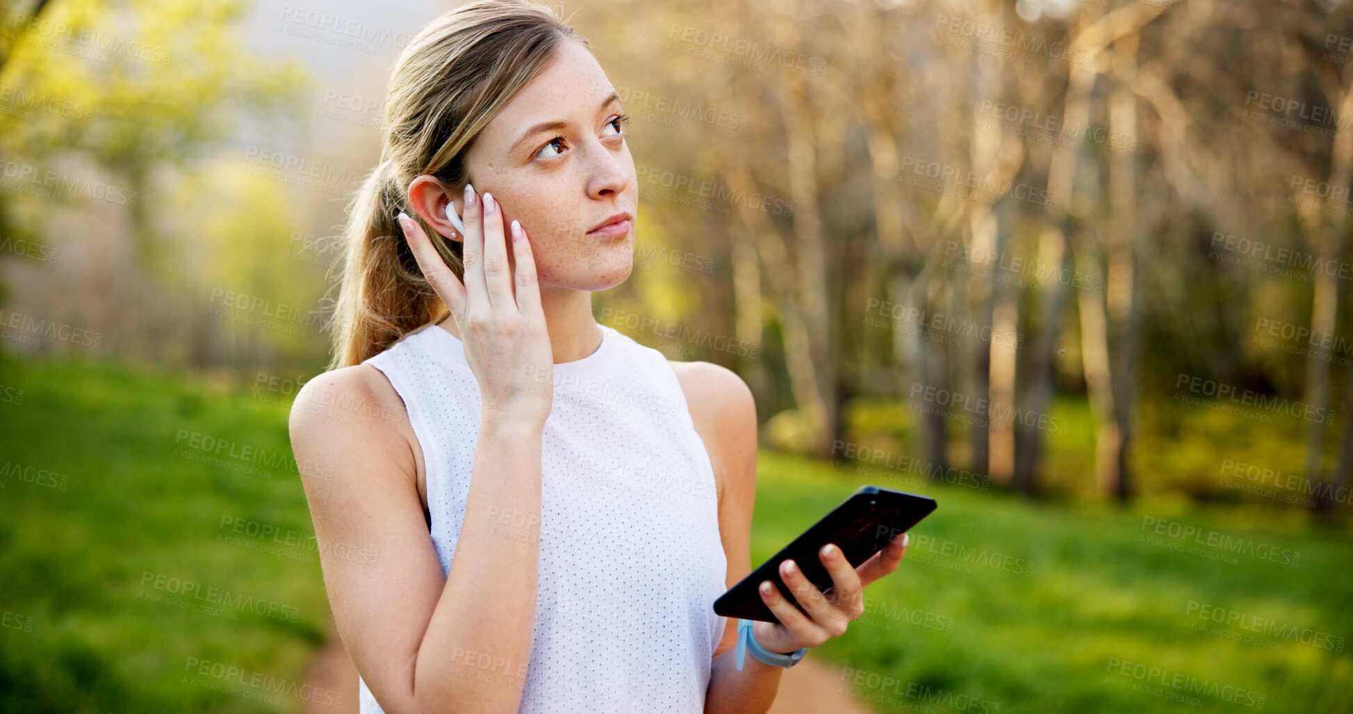 Buy stock photo Girl, thinking and phone in nature with fitness for running performance, tracking speed and marathon monitor. Athlete, runner and biometric in forest for wellness progress, music or earphones outdoor