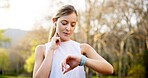 Girl, smart watch and check pulse in nature for running performance, tracking speed and fitness monitor. Athlete, runner and biometric in forest for wellness progress, heart rate or earphones outdoor