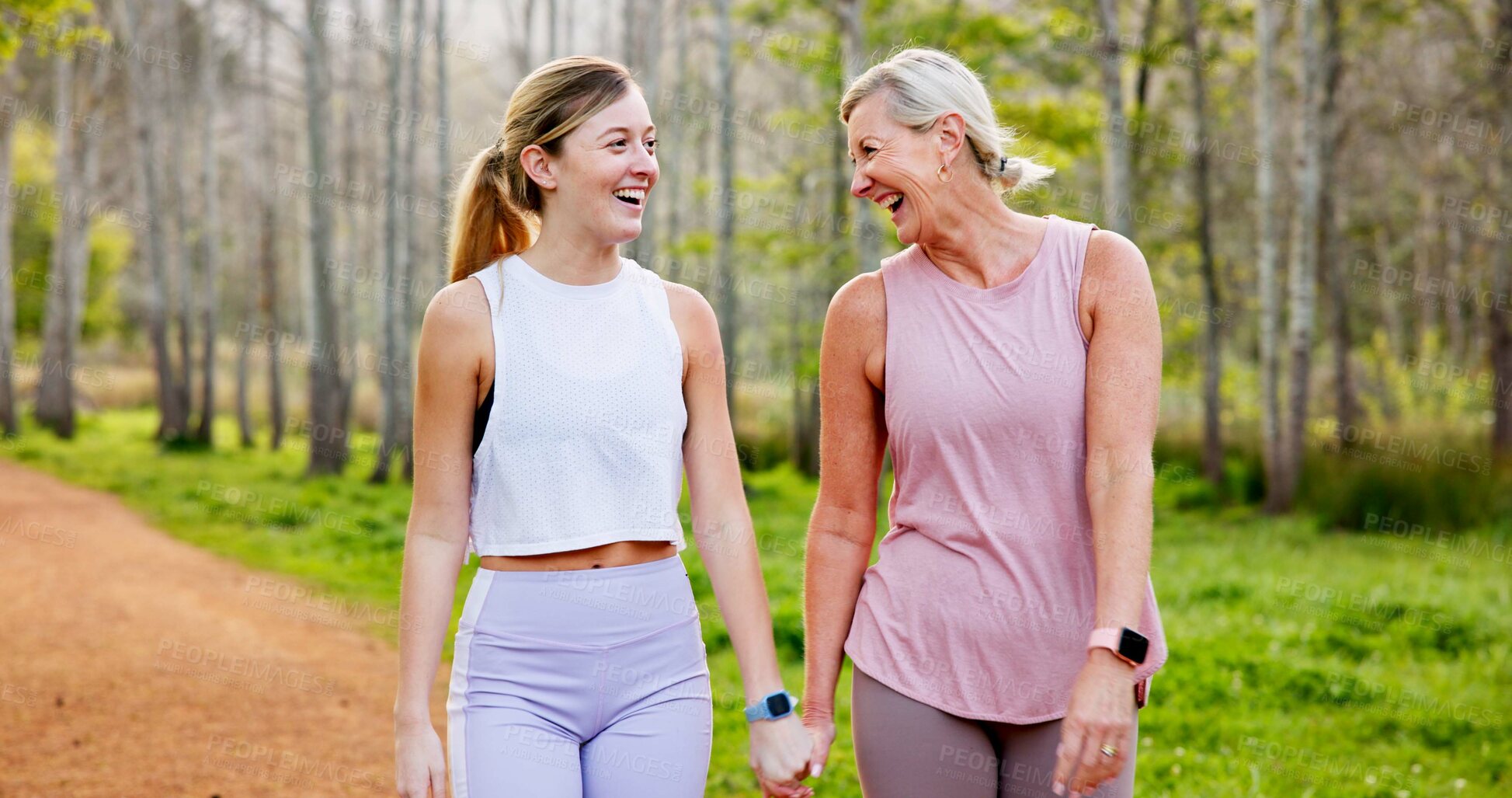 Buy stock photo Mother, daughter and holding hands in forest with hiking for fitness adventure, sightseeing or laughing. Bonding, mature woman or girl in woods with walking, holiday travel or talking on outdoor path