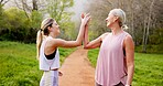 Fitness, women and high five in nature for support, well done and energy for exercise. Mature mother, girl and hand gesture on mountain trail for motivation, healthy relationship or bonding with care