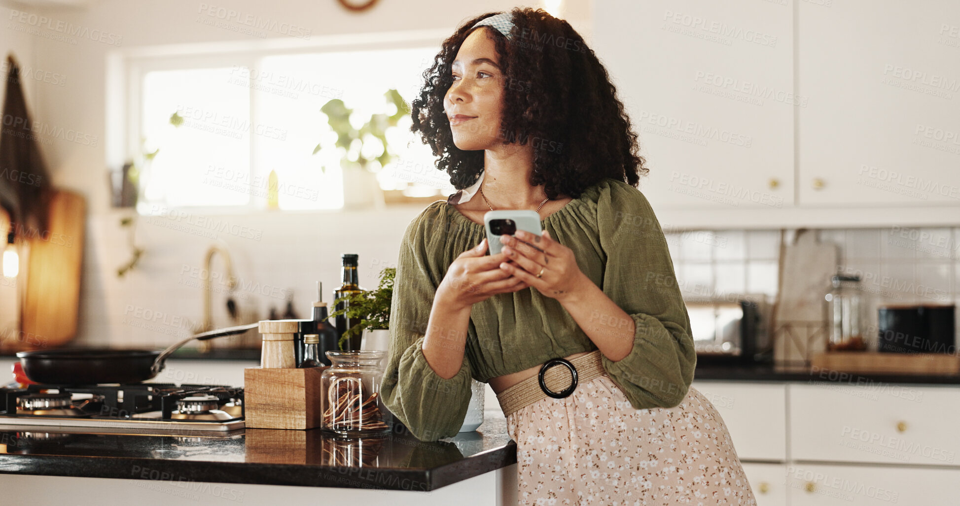 Buy stock photo Woman, thinking and phone in kitchen for social media, text message and research recipe ideas. Girl, mobile and day dream in home for connectivity, communication and smile for weekend planning