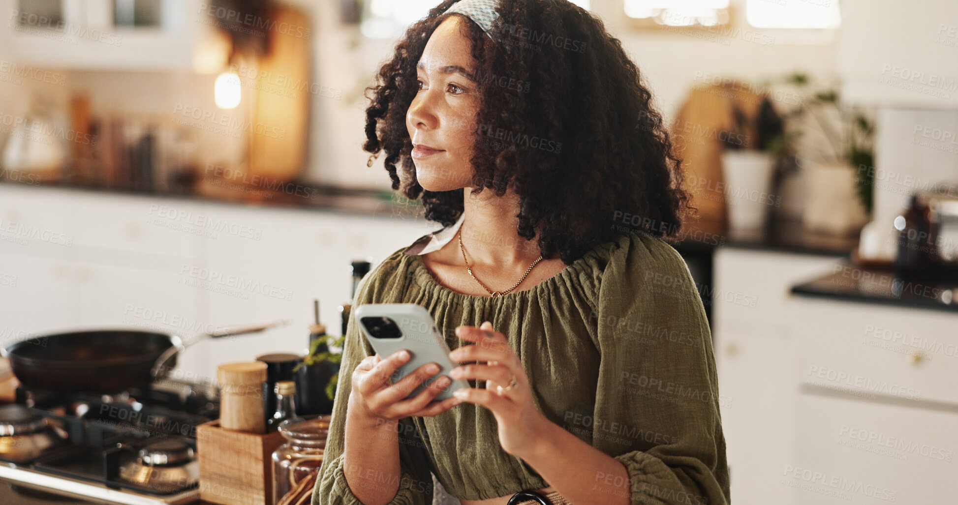 Buy stock photo Woman, thinking and mobile in kitchen for social media, text message and research recipe ideas. Girl, phone and day dream in home for connectivity, communication and smile for weekend planning