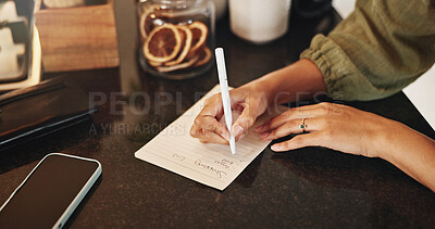 Buy stock photo Hands, women and writing on paper for shopping list, planning and groceries for household. Female person, housewife and home on kitchen counter or desk for house items, checklist and reminder