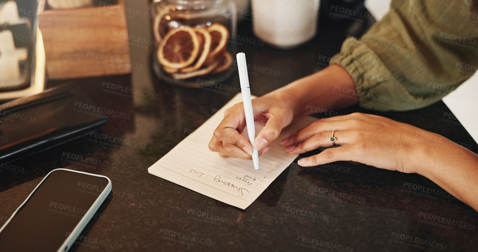 Buy stock photo Hands, women and writing on paper for shopping list, planning and groceries for household. Female person, housewife and home on kitchen counter or desk for house items, checklist and reminder