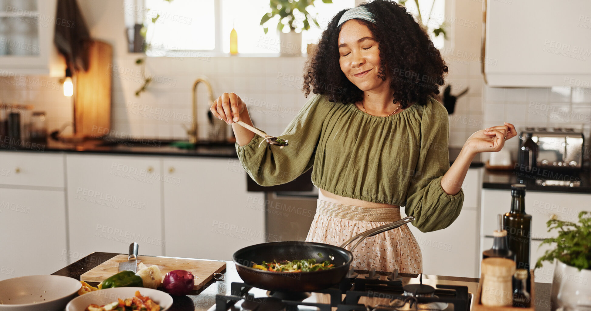 Buy stock photo Happy woman, cooking and ingredients with spoon in kitchen for stir fry, meal prep or flavor at home. Female person, chef and smile with organic food on stove for spices, recipe or taste at house