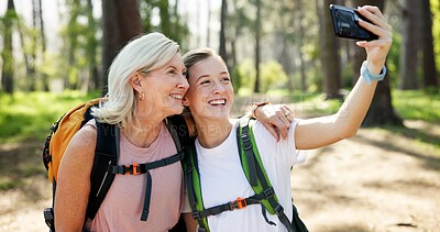 Buy stock photo Nature, hiking and women with smile for selfie, document memory and bonding for profile picture. Outdoor, senior mother and daughter with photography for social media, fitness experience and wellness