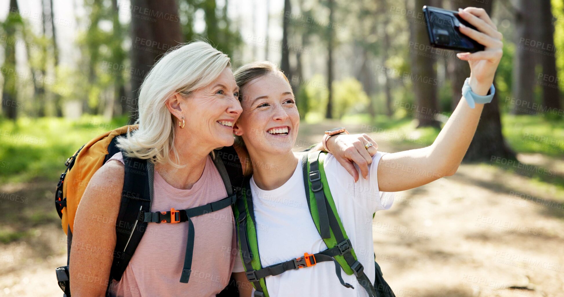 Buy stock photo Nature, hiking and women with smile for selfie, document memory and bonding for profile picture. Outdoor, senior mother and daughter with photography for social media, fitness experience and wellness