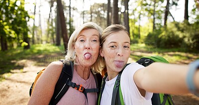 Buy stock photo Hiking, women and portrait with tongue out for selfie, document memory and goofy face for picture. Outdoor, senior mother and daughter with photography for social media, nature experience and silly