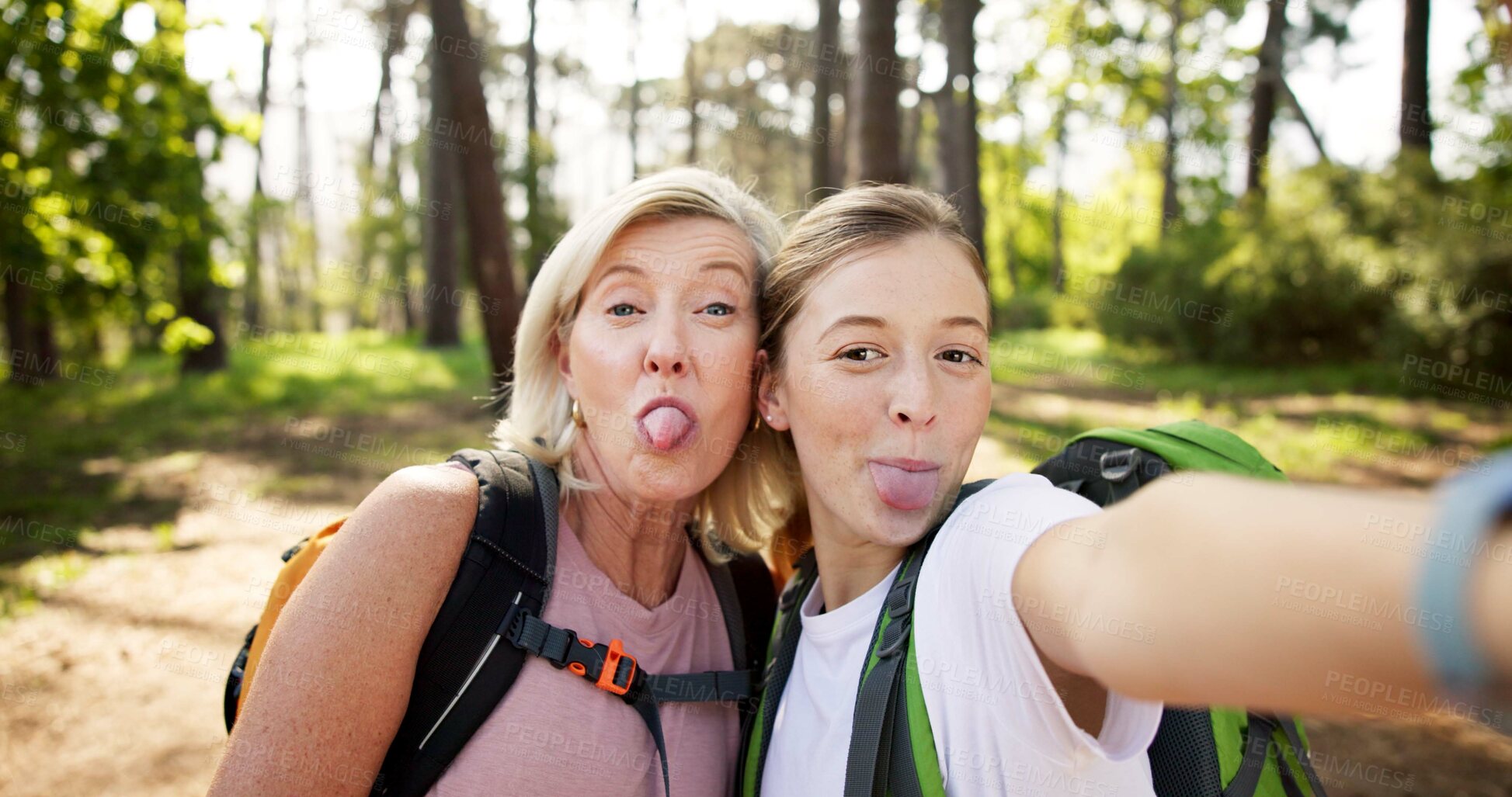 Buy stock photo Hiking, women and portrait with tongue out for selfie, document memory and goofy face for picture. Outdoor, senior mother and daughter with photography for social media, nature experience and silly