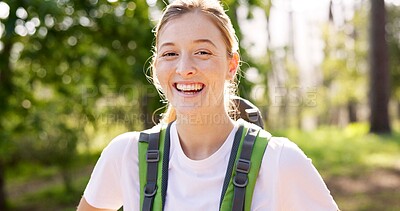 Buy stock photo Girl, portrait and hiking in forest with backpack for fitness adventure, sightseeing or explore nature. Trekking, person and happy for scenery in woods with walking, holiday travel and cardio hobby