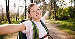 Happy woman, portrait and trekking with backpack for video call, travel memory or live streaming adventure in forest. Female person, influencer or smile with bag or wave for hiking journey in woods