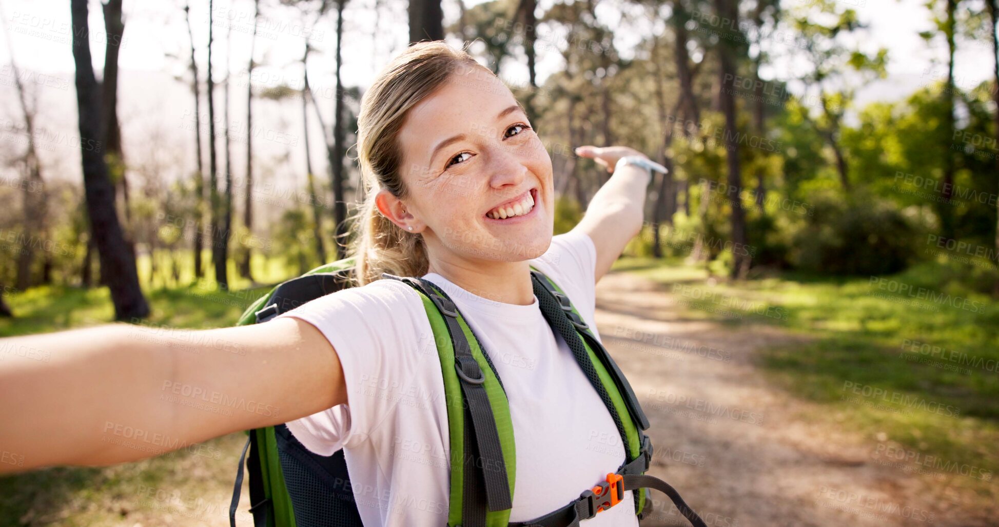 Buy stock photo Happy woman, portrait and trekking with backpack for video call, travel memory or live streaming adventure in forest. Female person, influencer or selfie with bag or wave for hiking journey in woods