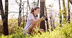 Woman, photographer and forest with camera for sightseeing, bird watching or observation in nature. Young, female person or hiker with photography in woods for picture, memory or outdoor photoshoot