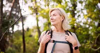 Buy stock photo Mature, woman and hiking in forest with backpack for fitness adventure, sightseeing and explore nature. Trekking, person and thinking of scenery in woods with walking, holiday travel and cardio hobby