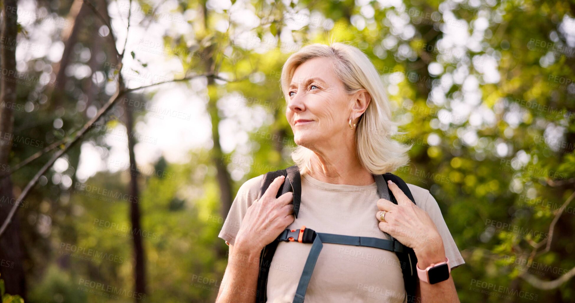 Buy stock photo Mature, woman and hiking in forest with backpack for fitness adventure, sightseeing and explore nature. Trekking, person and thinking of scenery in woods with walking, holiday travel and cardio hobby